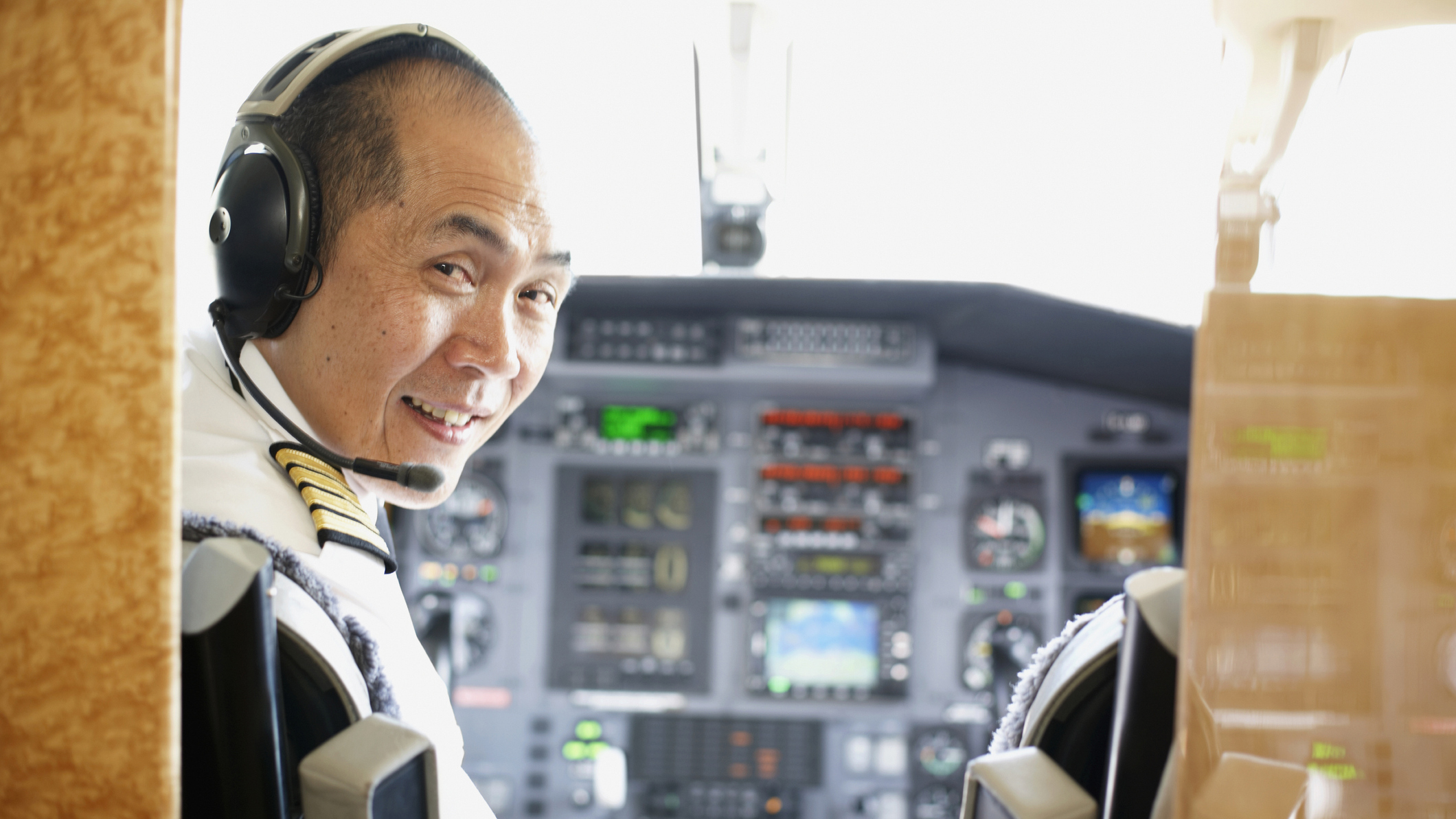 79384179 Close up of a pilot sitting in the cockpit of a plane.
