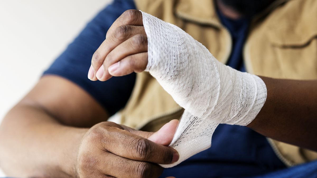 Mine worker bandaging hand Photo of a mine worker bandaging hand.