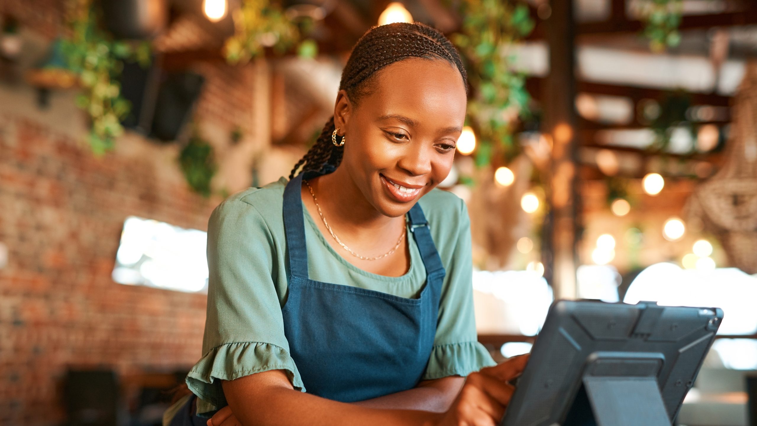 cashier Black woman working the cash register at a restaurant.