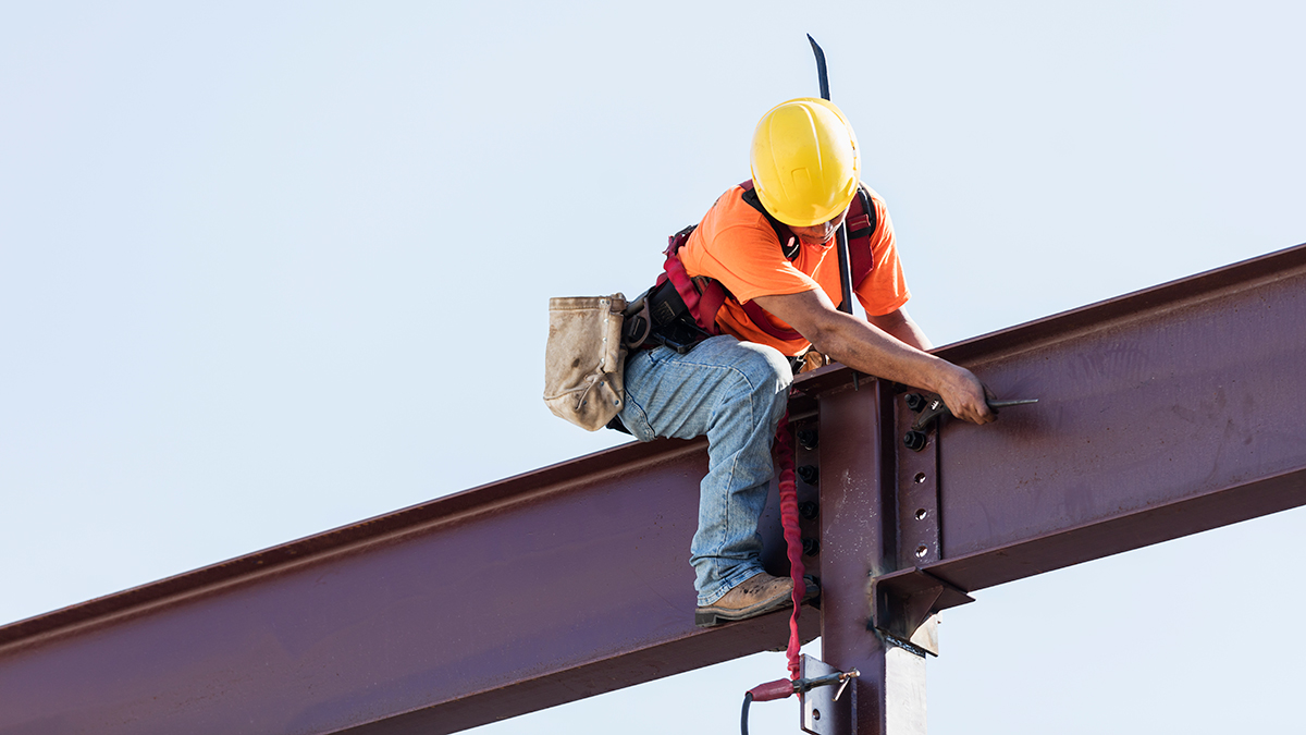 Construction worker on beam Construction worker on beam wearing hard hat.
