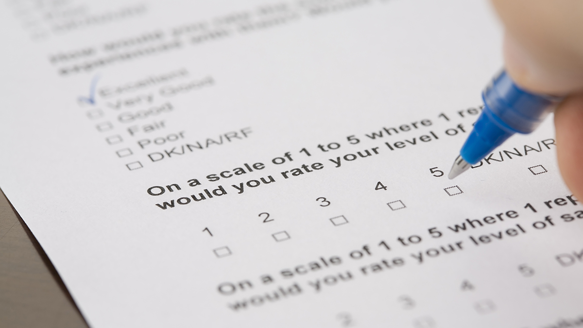 Person is holding a pen and filling out the Quality of Worklife Questionnaire