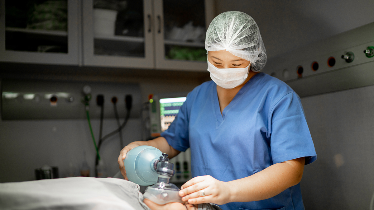 1239759436 Healthcare worker providing anesthetic gas to patient