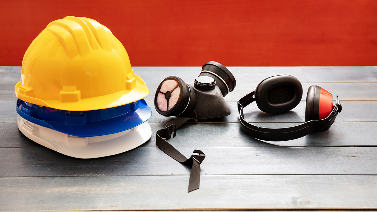 1264334836 A collection of PPE including helmets, a respirator, and hearing protection.