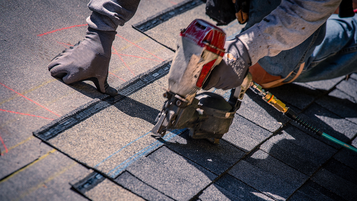— title missing — A nail gun being used on a roof