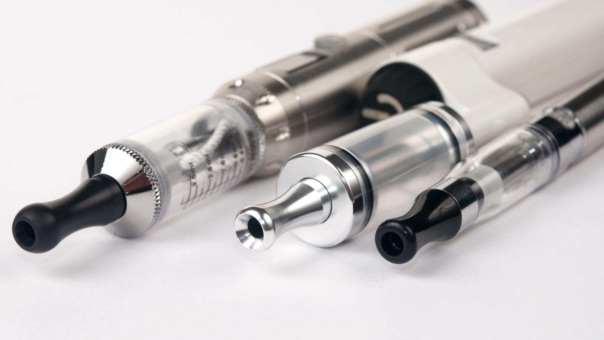 — title missing — Three different vape products line up.