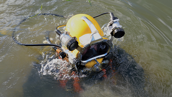 Commercial Diver Commercial diver prepares to descend below fishing vessel to perform repairs. Image credit: iStock / Getty Images Plus