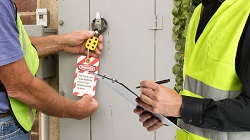 auditing Two men engaging in a LOTO audit