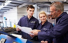 training Three workers consulting on LOTO training