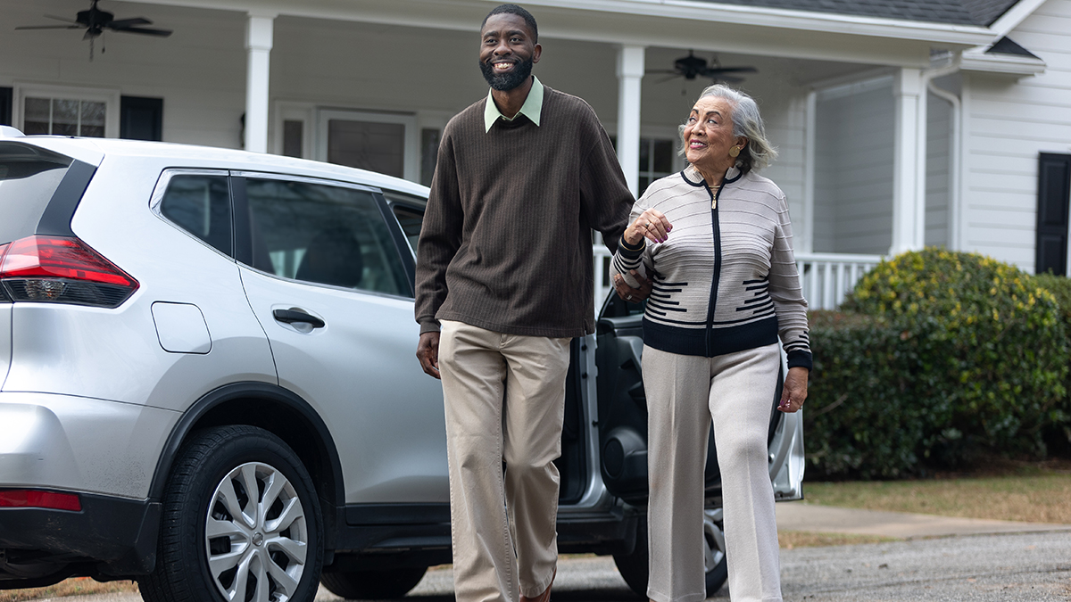 CDC Transportation Safety-850 Man escorts older adult woman from car