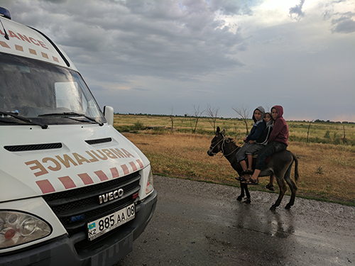 children-riding-donkey Children ride a donkey home at the end of the day in the study region of Zhambyl Oblast.