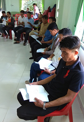 Local farmers receive training on how to use the mobile app.