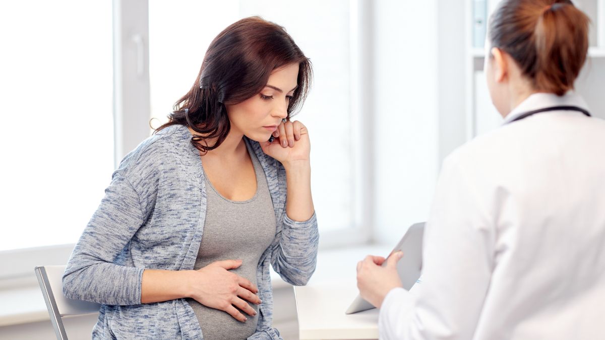 Healthcare provider talking to pregnant patient Healthcare provider talking to pregnant patient.