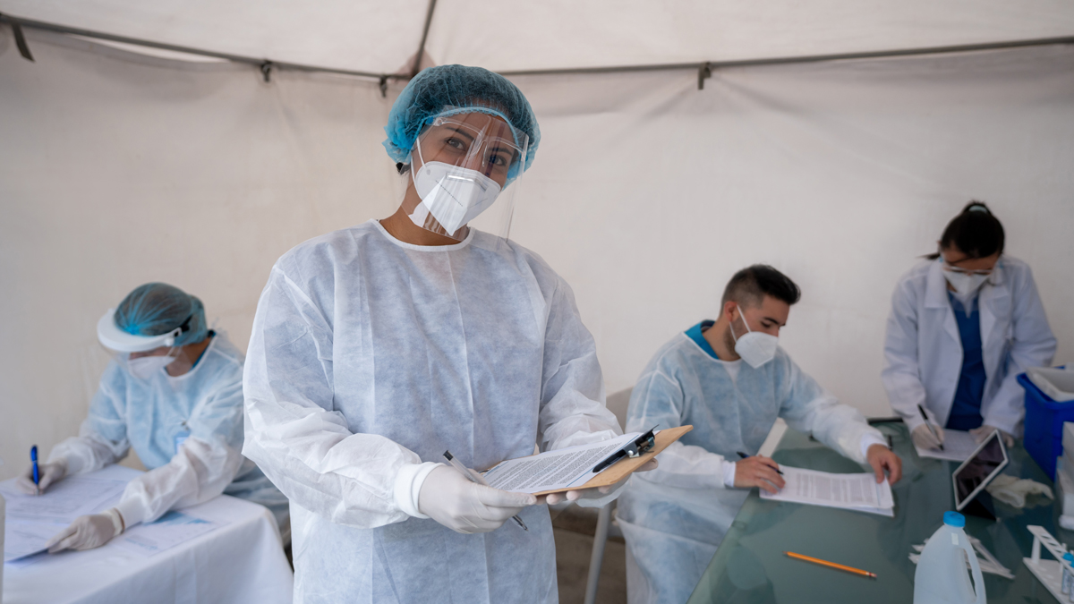 COVID healthcare worker Healthcare worker working at a COVID-19 vaccination stand