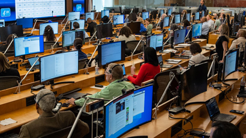 — title missing — Emergency Operations Center (EOC) full of staff working.
