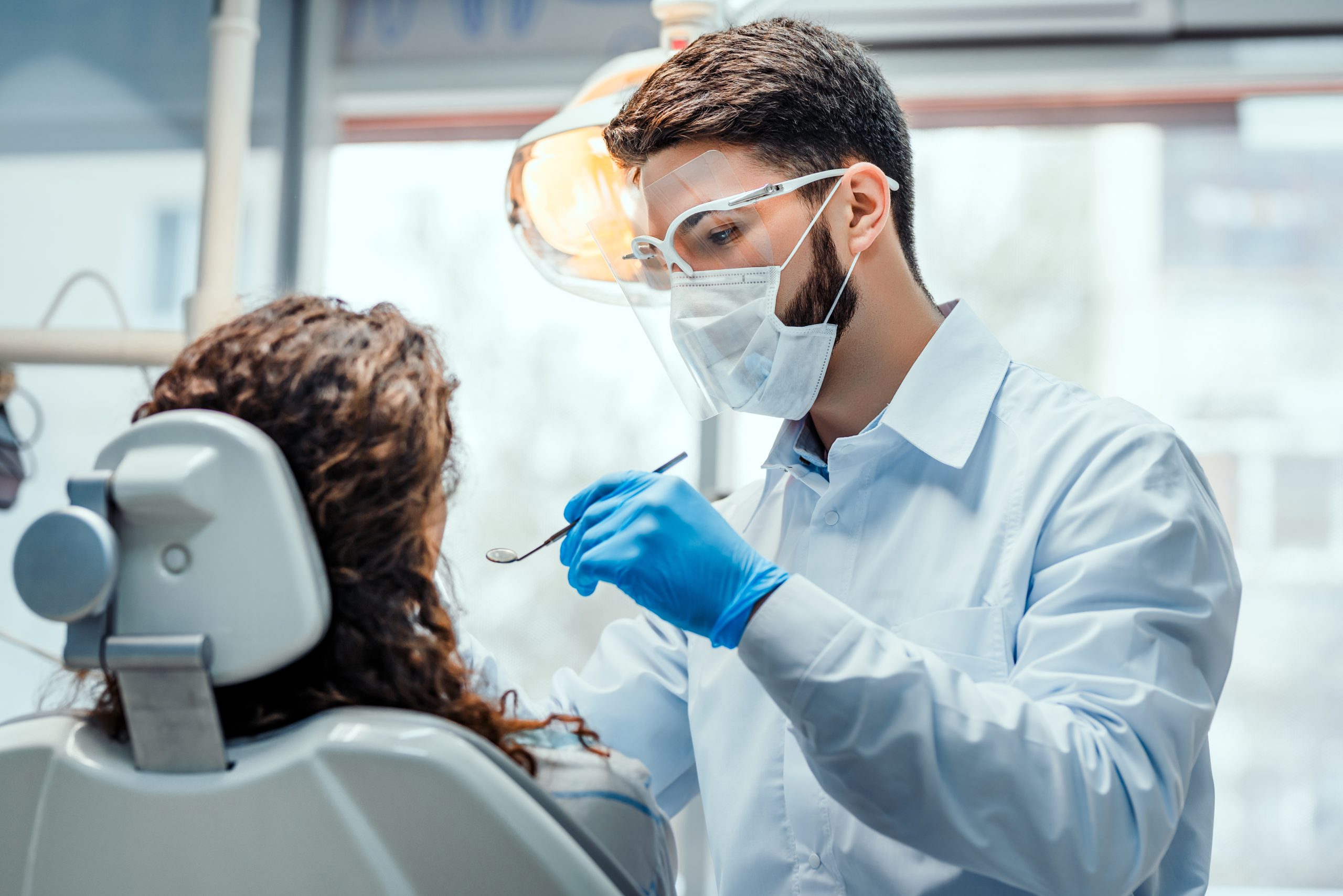 Dentist examining patient.