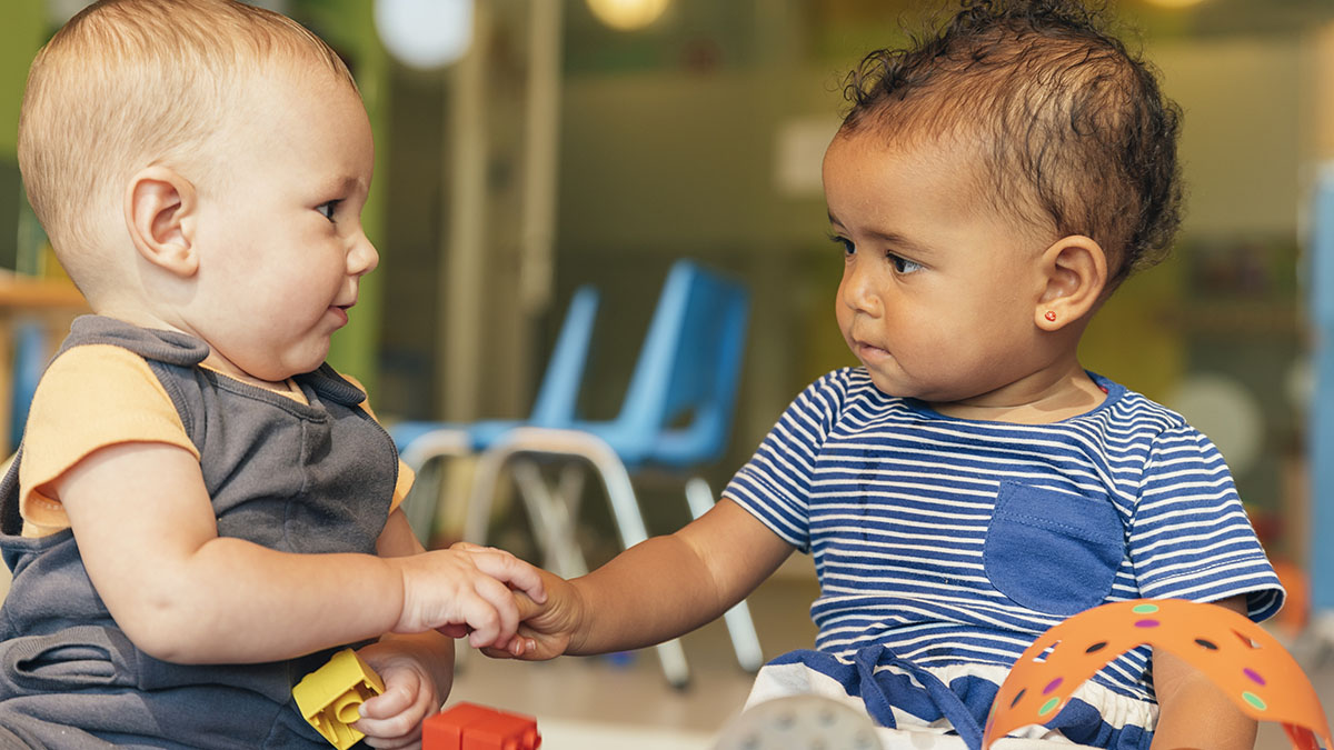 Two toddlers playing together at preschool. Two toddlers playing together at preschool.