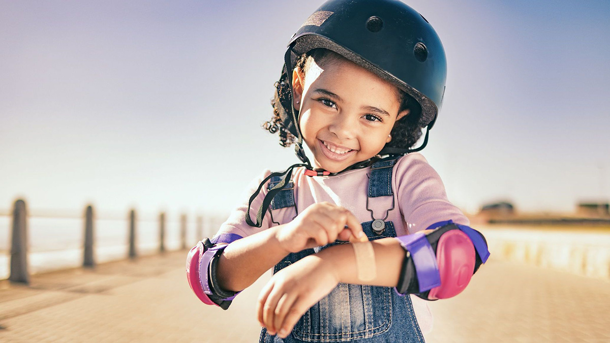 Girl with a helmet for safety Happy, smile or girl with helmet for exercise, wellness health at beach, sea or ocean