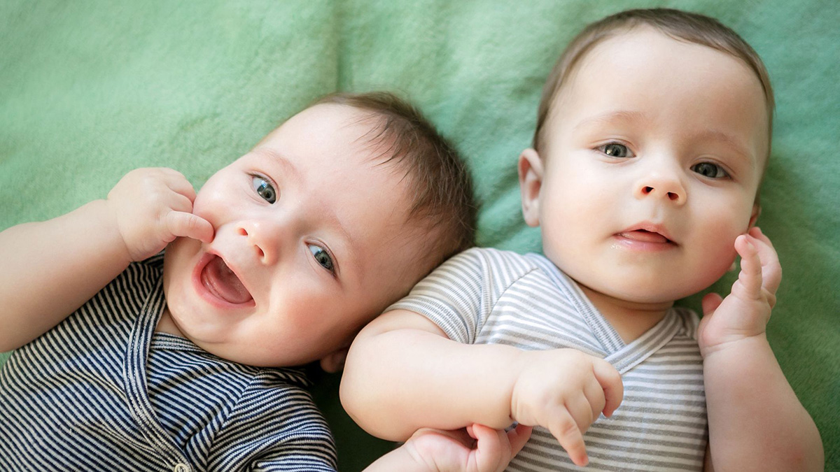Twin boys Newborn twins boys are lying on the bed