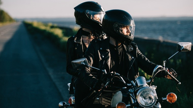couple_on_motorcycle A couple on a motorcycle wearing helmets and jackets