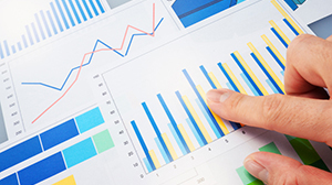 chart graphic Finger pointing to a generic graph page with several colorful graphs present.