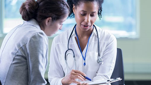 Consulting HCP A clinician consults with a female patient.