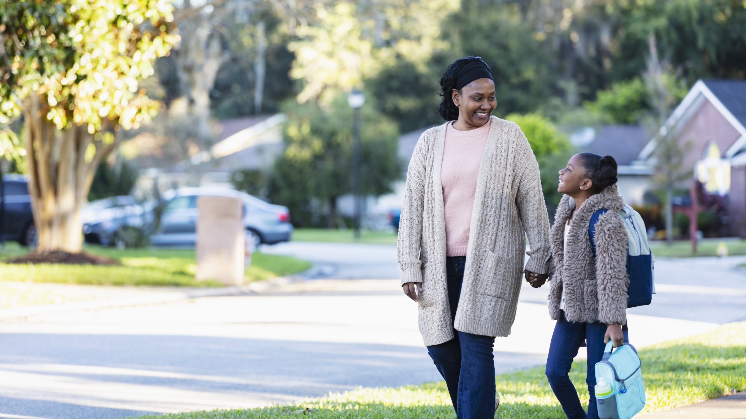— title missing — Mom and daughter walk to school.
