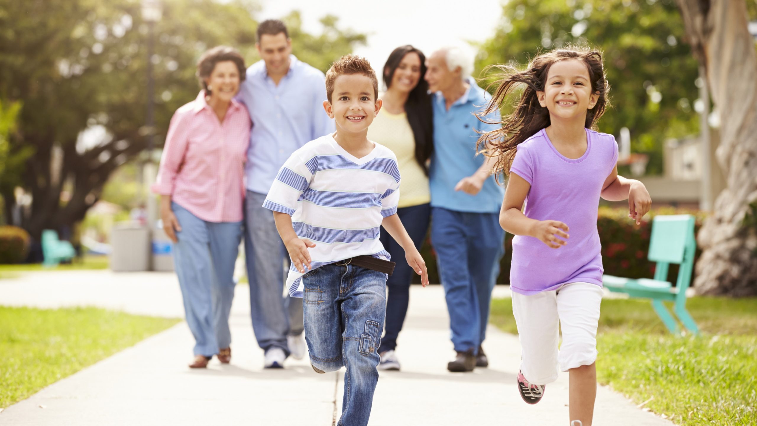 — title missing — Family on a walk with 2 kids running in front of 4 adults.