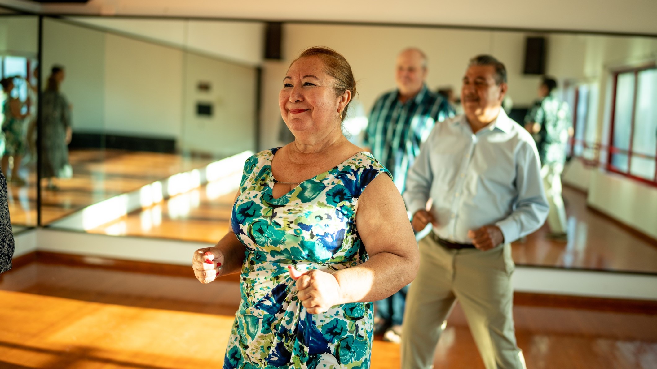 -- title missing -- Older adults dancing in a room.