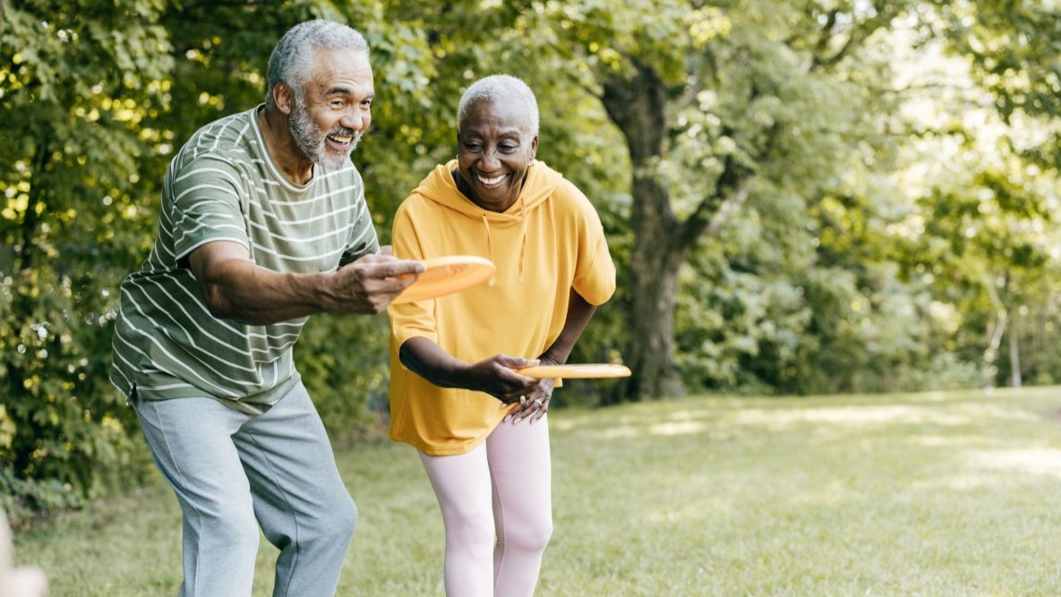 — title missing — Older couple playing frisbee