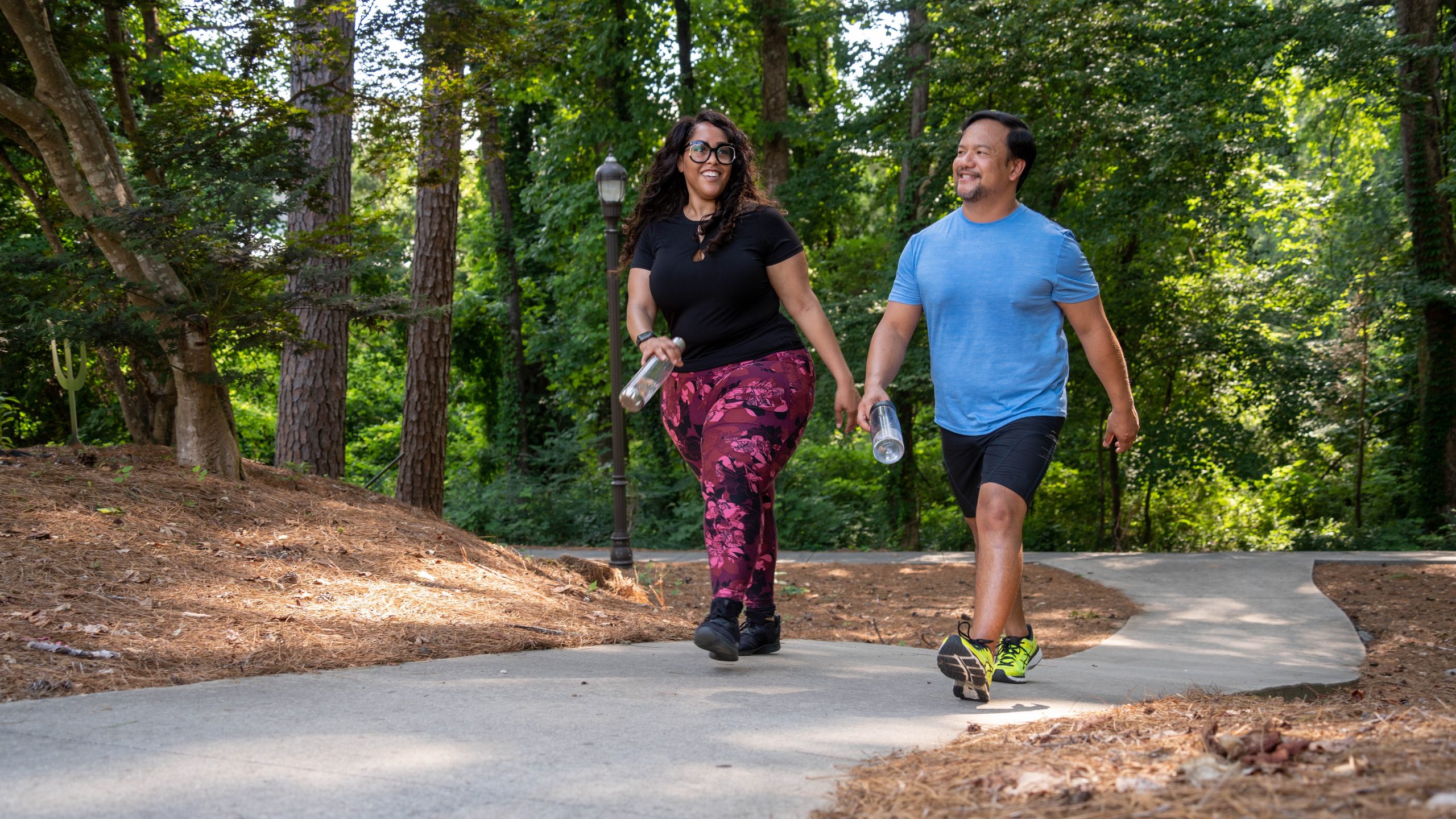 — title missing — Two people walking on a path in the park
