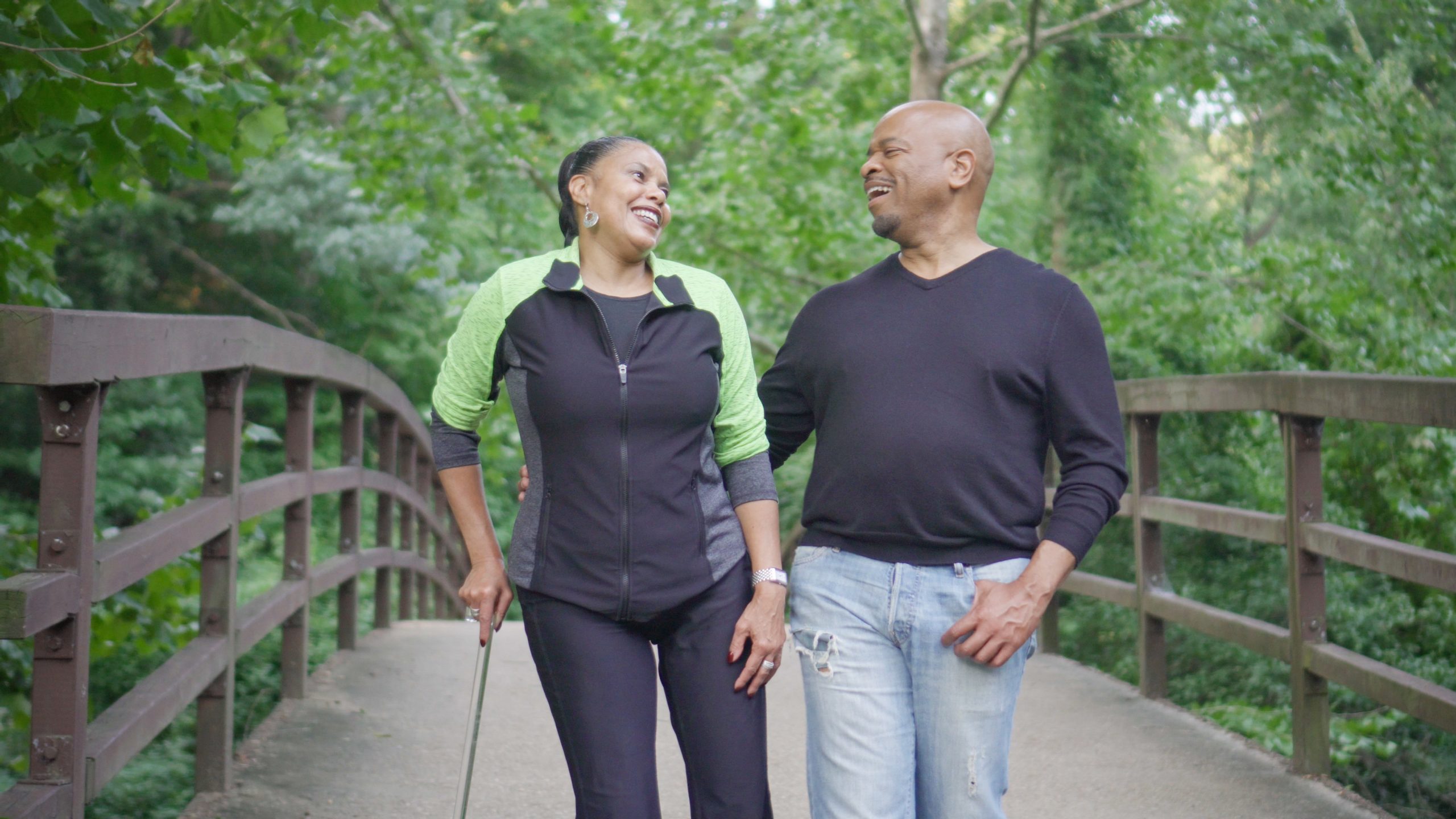 iStock1041468594.jpg Woman with cane and man walking in nature