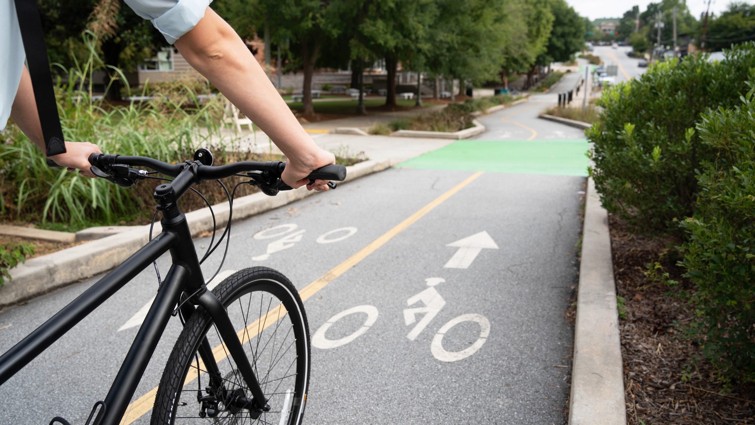 — title missing — Person biking on a protected bike lane.