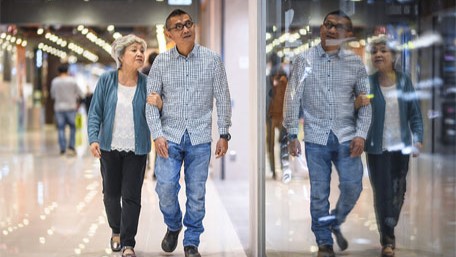 — title missing — Couple walking in an indoor mall.