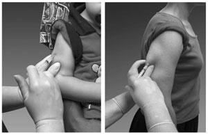 vaccine 3 Upper arm being pinched by a hand and injected with a small syringe.
