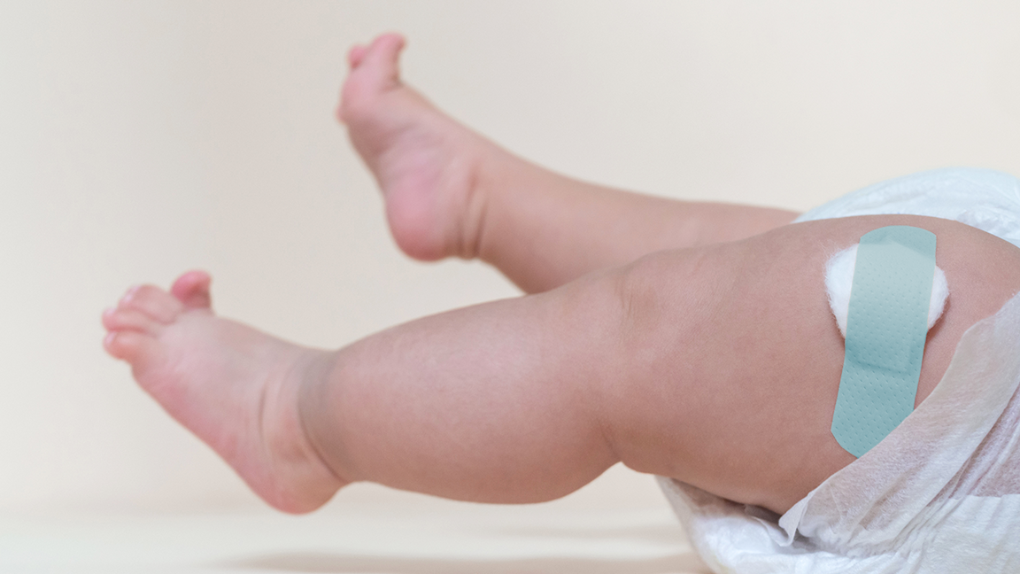 baby leg with bandaid Legs of a baby lying down with a Band-Aid on its leg after receiving a vaccine.