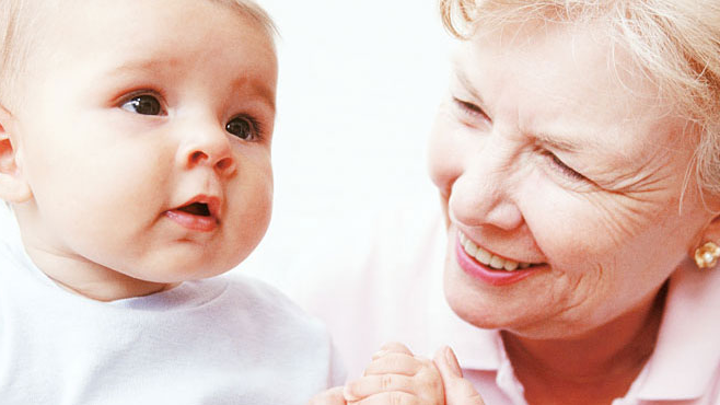 Grandmother and baby A grandmother smiles at her grandchild.