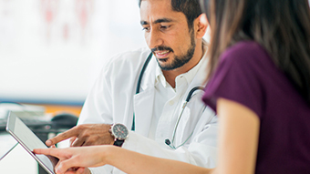 Healthcare providers Two healthcare providers looking at something on a tablet