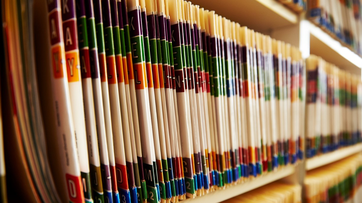 Bookshelves filled with bound reports.
