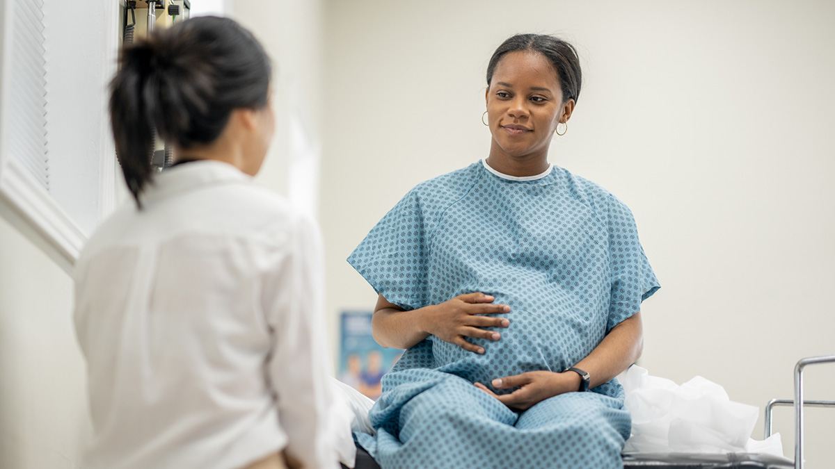 Pregnant woman receiving medical screening A pregnant woman receives a medical screening in a doctor's office.