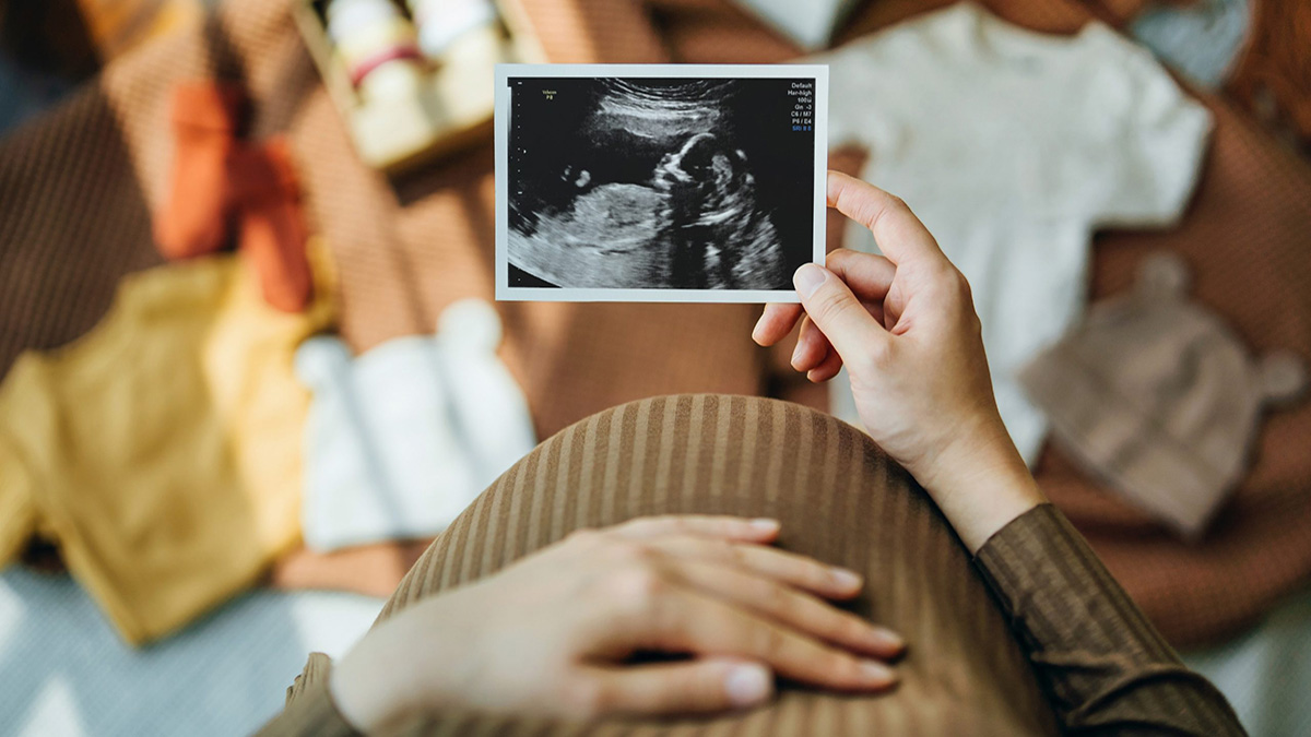 Ultrasound Pregnant person looking at ultrasound image