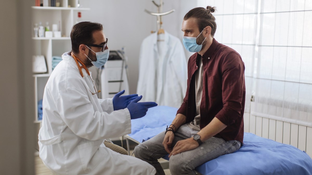 Patient Doctor Photo of a man talking to his doctor
