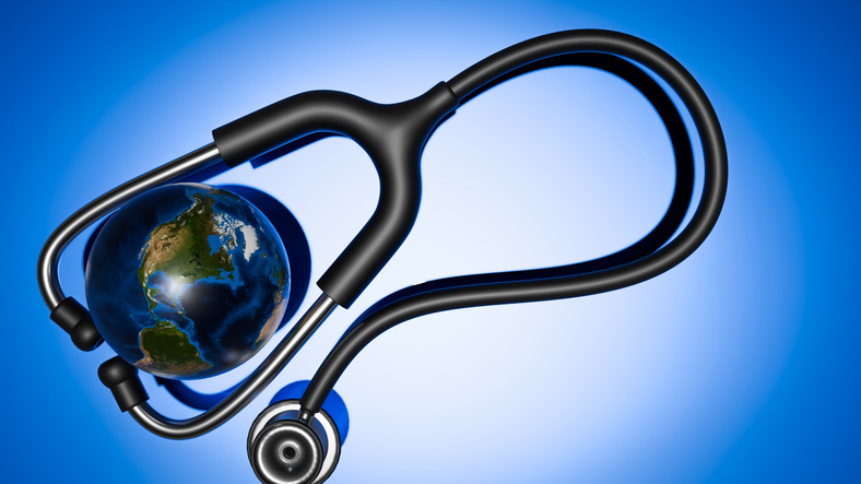 stethoscope on blue background with small ball depicting the earth