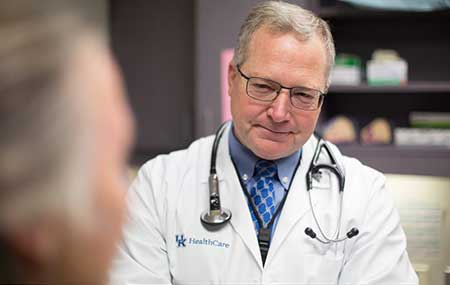 Dr. Mullet photo Photo of Dr. Timothy Mullett talking with patient.