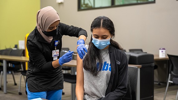 vaccineclinic646x32111.jpg A person getting a vaccine at a clinic.