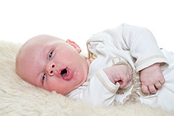 Infant Lying Down_v1 Infant lying down on blanket, coughing.