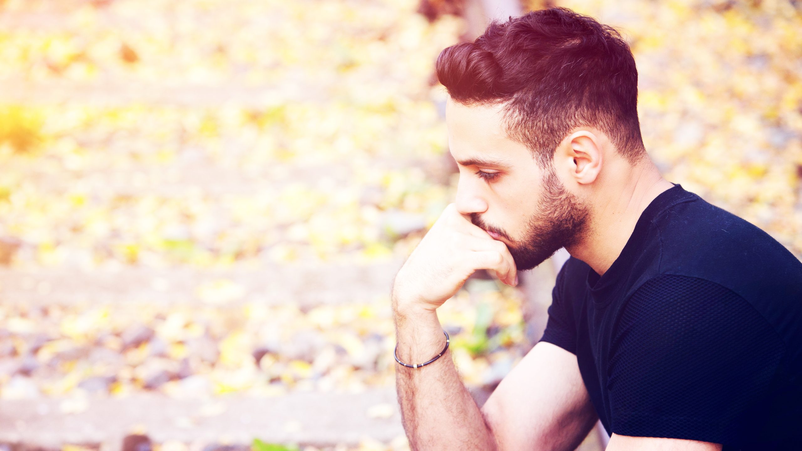 Young Man Sitting on Train Tracks Pensive Young Man Sitting on Train Tracks Pensive