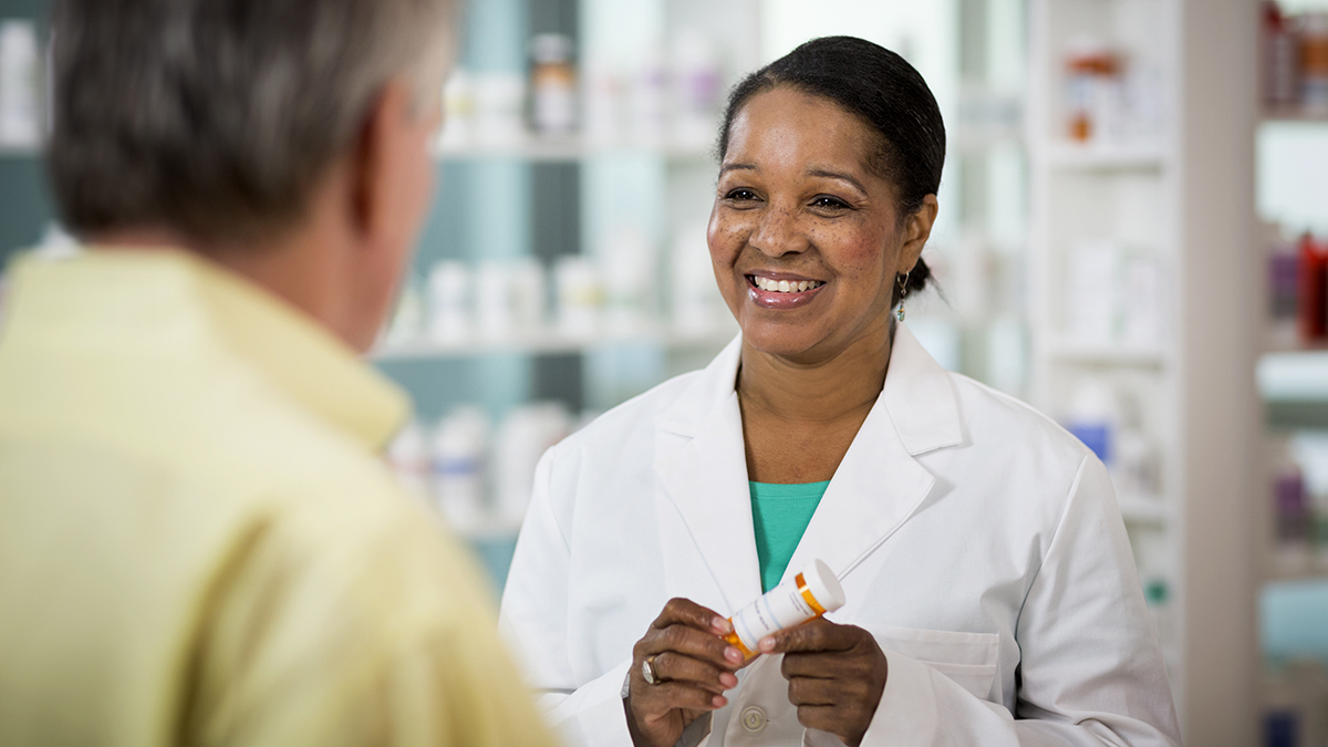 Pharmacist talking to patient about a prescription