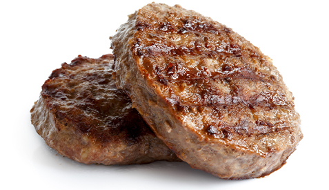 ground-beef-2023-477px Two ground beef patties on a white background.