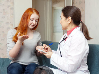 A school nurse talking with high school student A school nurse talking with high school student.