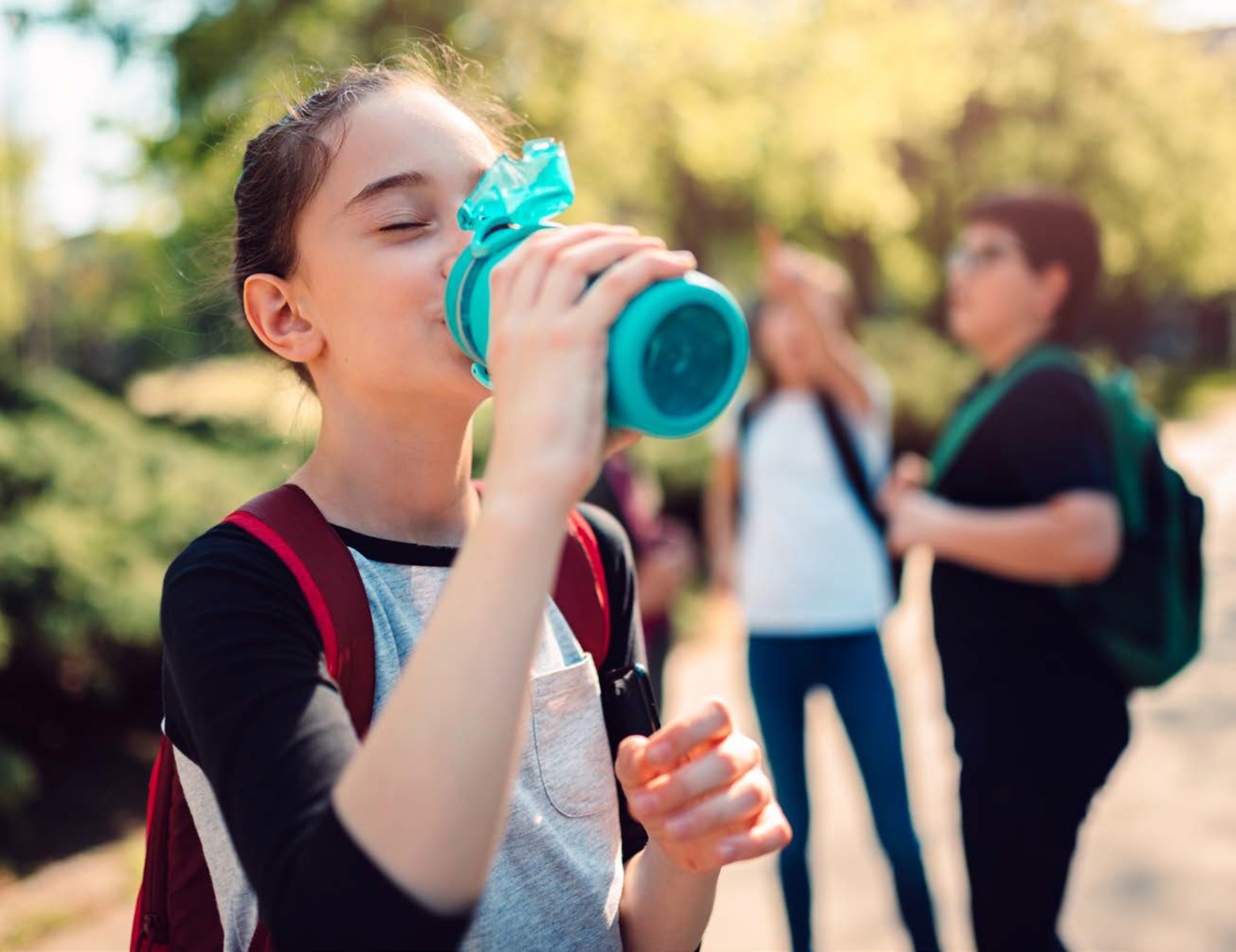 Young girl drinking from reusable water bottle Young girl drinking from reusable water bottle.